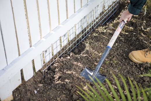 Keep dog from going under clearance fence